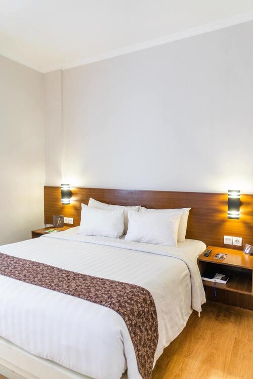 Hotel Bed with nightstands and lamp.